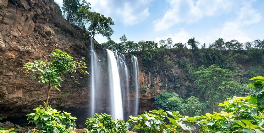 Breathtaking view of Vellappara Waterfalls in Kerala, cascading down lush green cliffs.