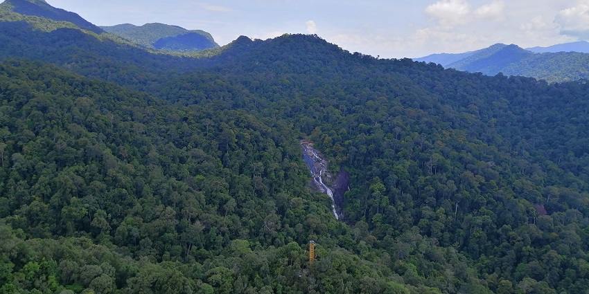 Telaga Tujuh Waterfalls in Langkawi, cascading over rocks surrounded by lush greenery.