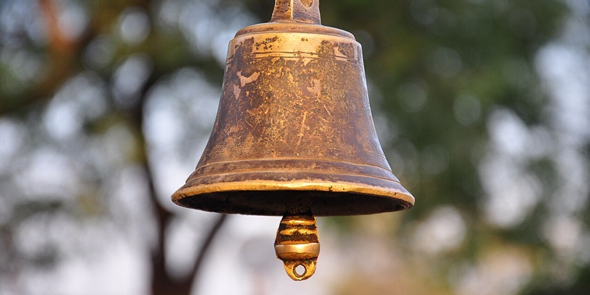 Image of a bell hanging near the water pond at the Thousand Pillar Temple