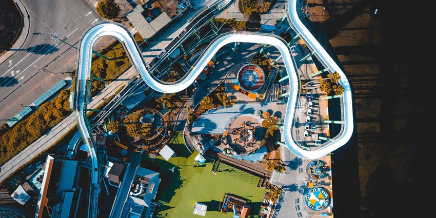 Aerial view of a thrilling giant water sledge in the Amusement water park amidst a city