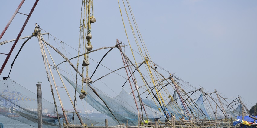 Scenic view of Vypin Beach with golden sands and fishing boats by the Arabian Sea.