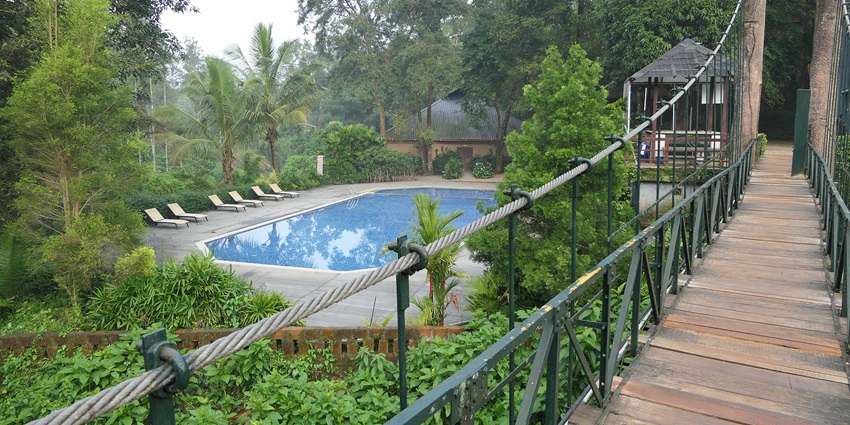 Scenic Vythiri resort surrounded by lush greenery and misty hills in Wayanad, Kerala.