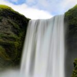 The view of beautiful waterfall, lush greenery and blue sky - best waterfalls in India