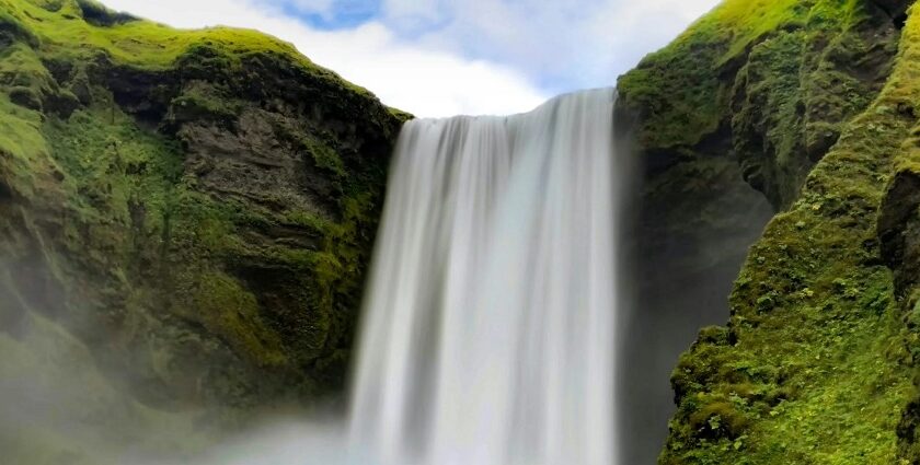 The view of beautiful waterfall, lush greenery and blue sky - best waterfalls in India