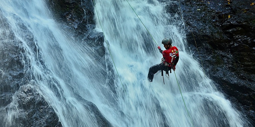 Indulge in waterfall rappelling on your trip to Thusharagiri Waterfalls, Kerala, India.