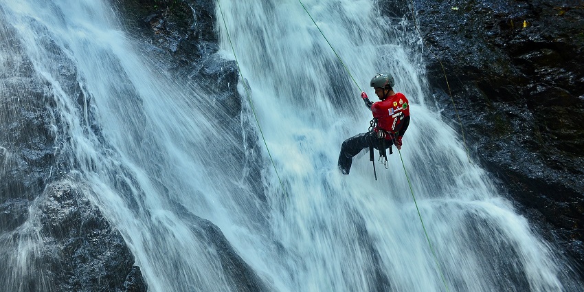 Indulge in the adventurous waterfall rappelling at the Meenmutty Waterfalls, Kerala.