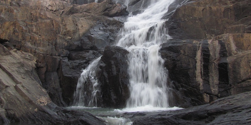 Chethalayam Waterfalls cascading over rocks surrounded by greenery - Wayanad adventure Parks