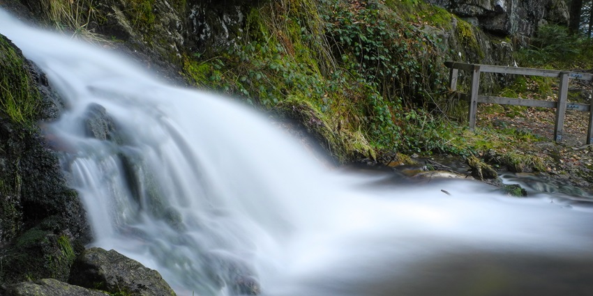 Scenic view of a beautiful waterfall descending in the forest somewhere in the forest