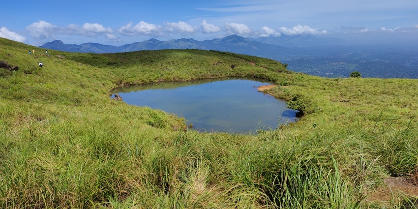 A picture of the beautiful Heart Lake at the Chembra Peak in Wayanad, offering a scenic experience