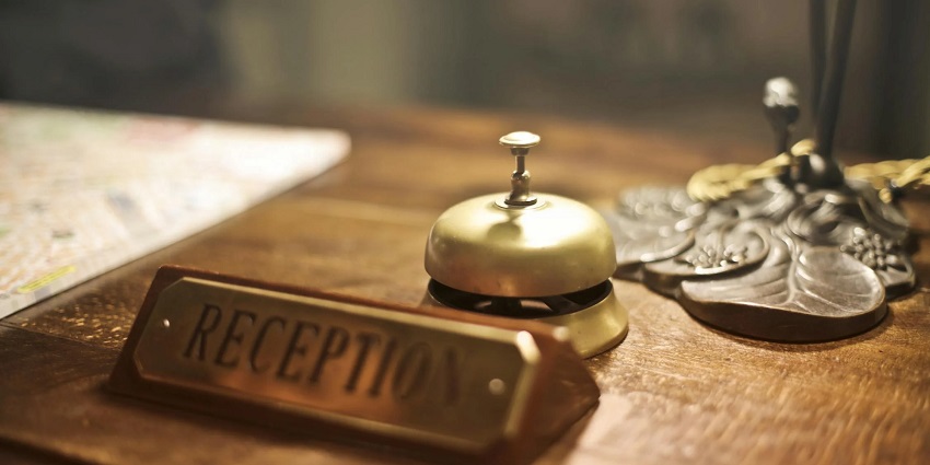 A view of a reception with a bell on the table. Options to stay in Red Skin Island.