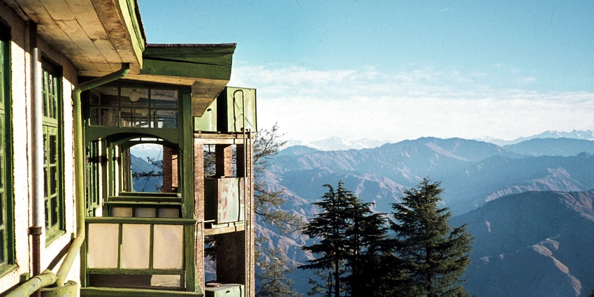 A captivating view of Wildflower Hall with a scenic backdrop of sky-high mountain peaks