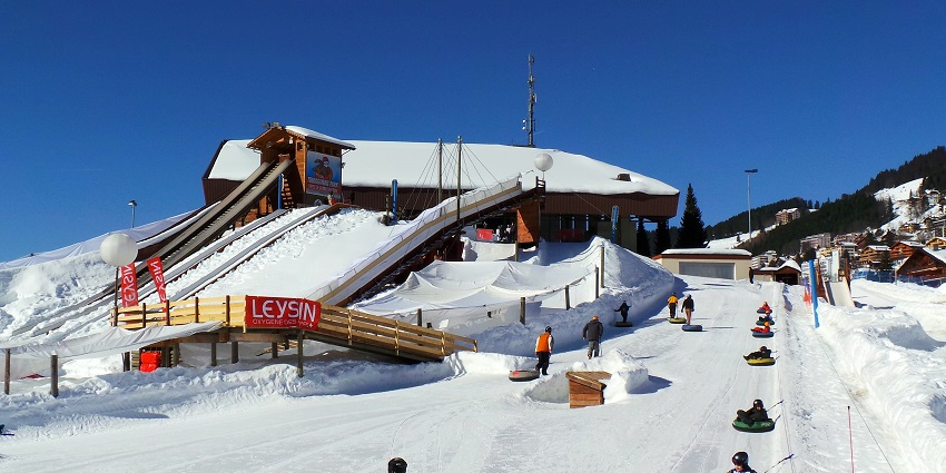 Tobogganing down a snowy hill, enjoying winter fun - best things to do in Kufri.