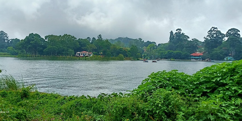 Serene water body surrounded by lush greenery - hill stations in tamilnadu and kerala