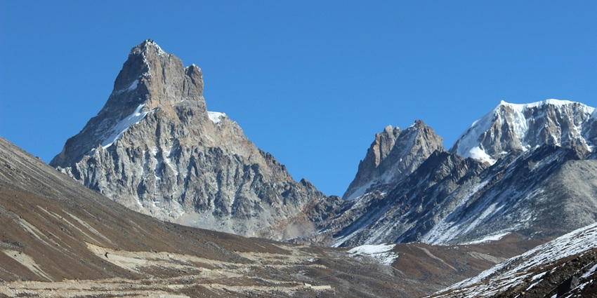 A scenic view of Zero Point decked with snow-clad peaks in Yumthang Valley, Sikkim.