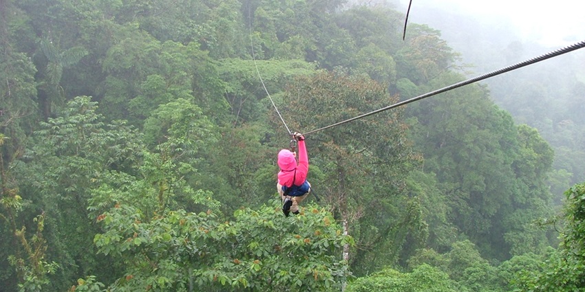 Traveller enjoying ziplining - best things to do near Chalakudy waterfalls kerala