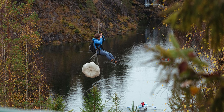 View of a adventure loving tourist ziplining over Marmala waterfalls