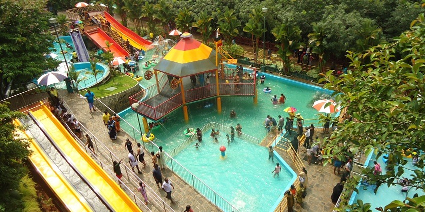 People enjoying a swimming pool in the water park
