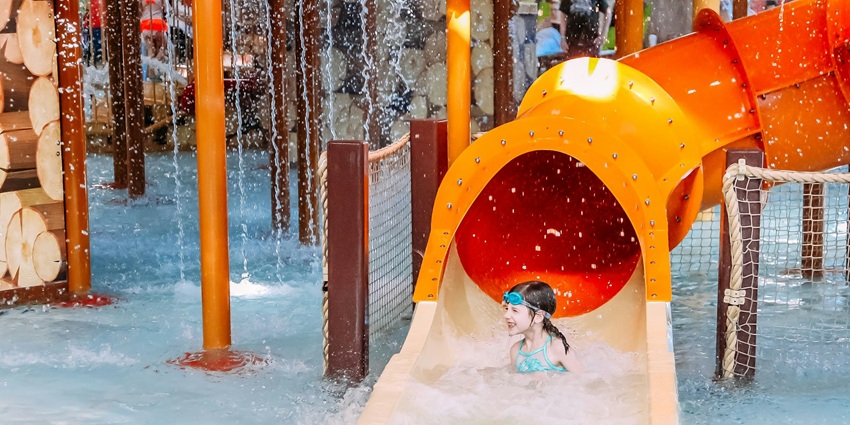 A child enjoy the thrilling water slides and rides at a fun water park.