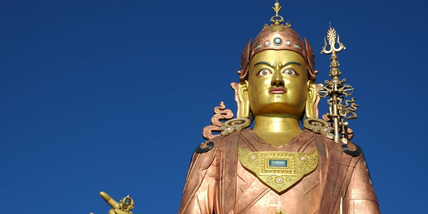 A tall stature of a Buddhist guru at a monastery