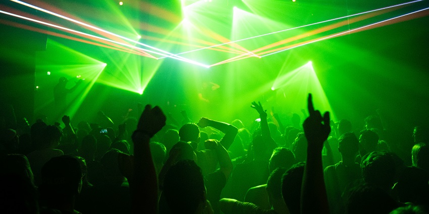 An inside view of people grooving to the beats and disco lights in 19th Hole Pub