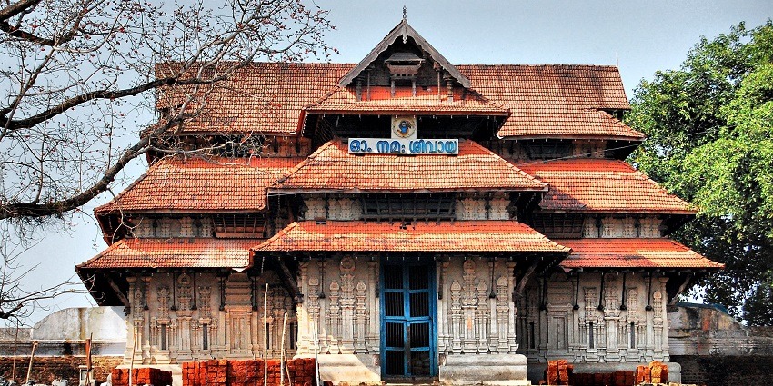 A frontal view of a temple with traditional Kerala architecture and intricate designs