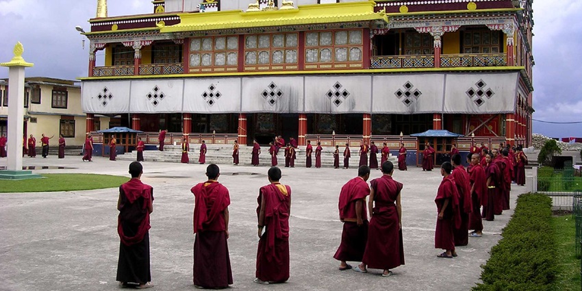 Buddhist monks standing outside a monastery
