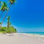 A mesmersing view of a tropical beach under the blue sky, a must visit spot in Thailand.