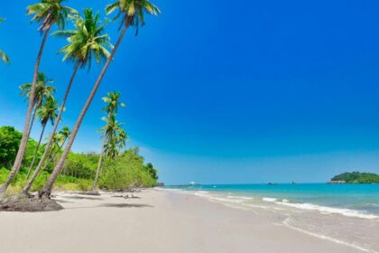 A mesmersing view of a tropical beach under the blue sky, a must visit spot in Thailand.