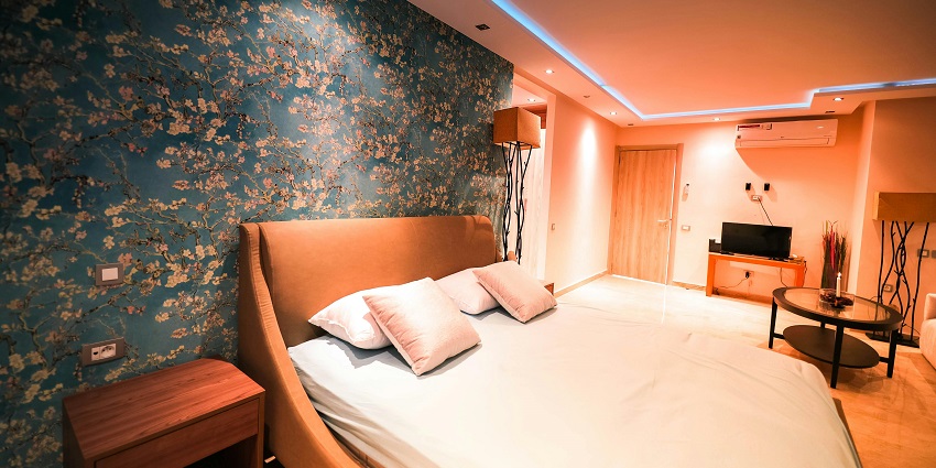A serene, empty bed in a softly lit room, creating a peaceful and inviting atmosphere.