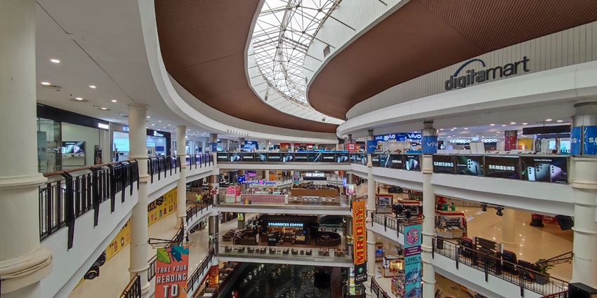 A picture of the interiors of a shopping mall with numerous brand stores all around