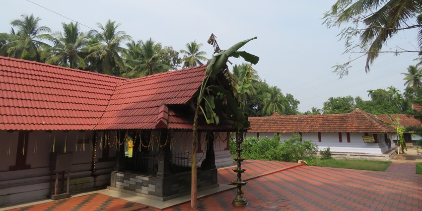 The entrance gate with a banana tree, of one of the sacred temples of Kerala, India.