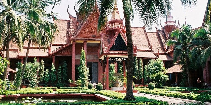 Gardens with pool, bushes and palms in the grounds of National Museum Phnom Penh.