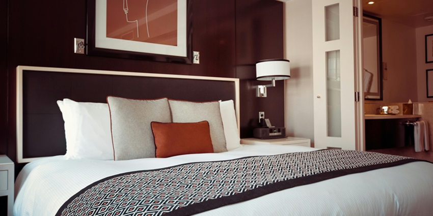Black and grey bedspread on a bed with matching pillows, creating a modern, cosy look.