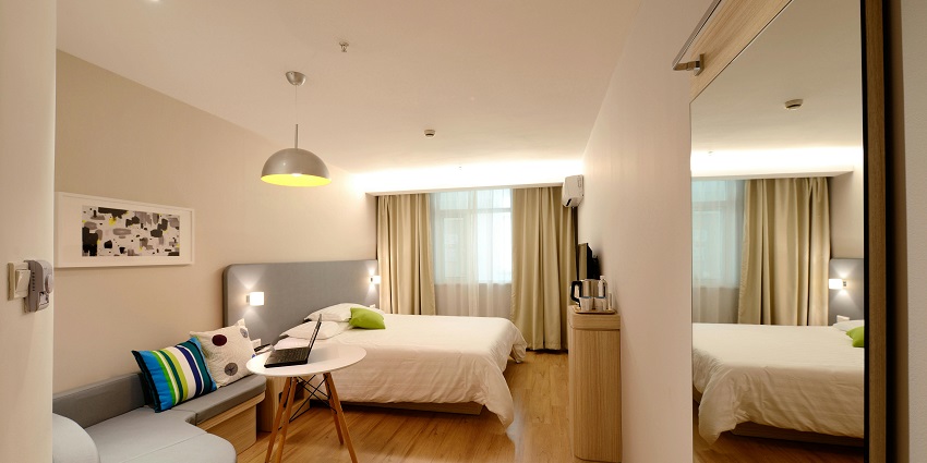 Cosy hotel room with modern furnishings, comfortable bed, and ambient lighting.