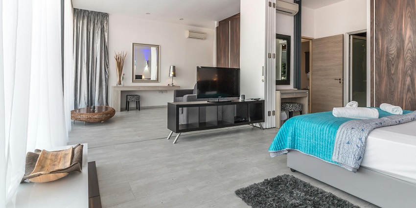 A stylish modern bedroom featuring a cosy bed, elegant decor, and soft lighting.