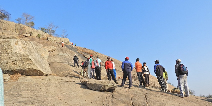 People climbing rocks during daytime