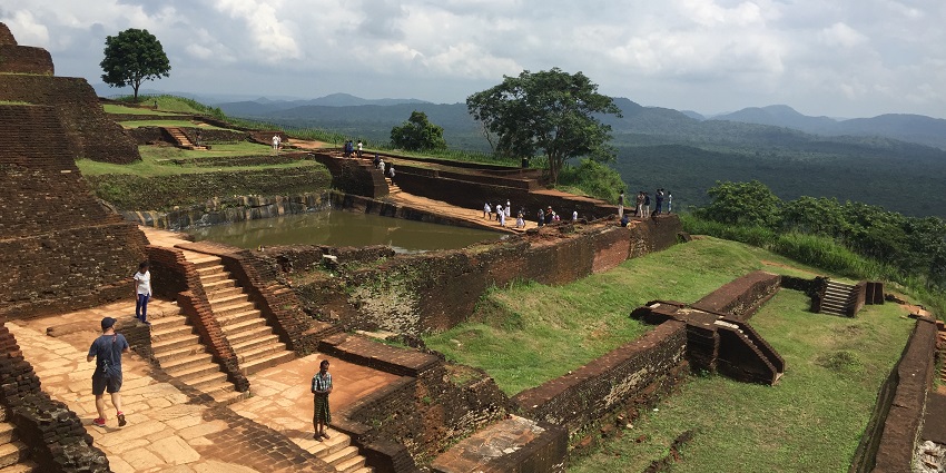 Aerial view of Sigiriya rock fortress, showcasing its ancient ruins, lush greenery