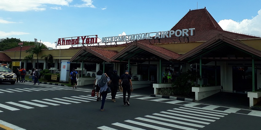 Tourists walking in and out of the entrance gate of this airport prior to their flights