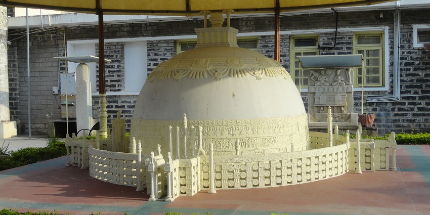 Model of the Amaravati stupa, showcasing intricate carvings and historical architecture.