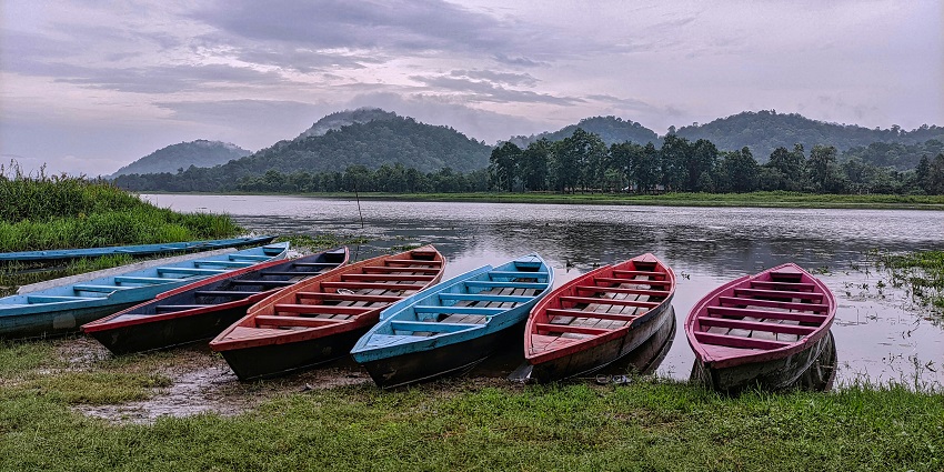 Group of hand-roved boats at the shore of a river somewhere in the idyllic hill of Assam