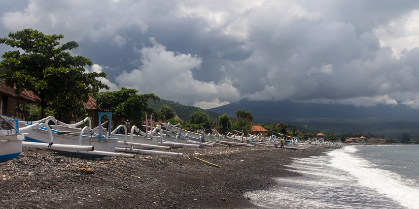The volcanic black sands of Amed Beach are ideal for a relaxing romantic retreat in Bali