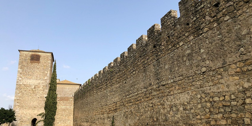Ancient mediaeval city walls in Évora, Portugal, showcasing historic architecture and charm.