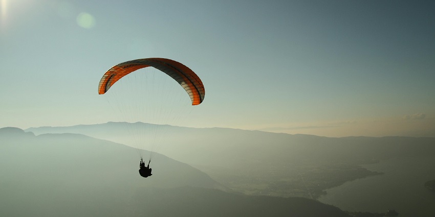 A picturesque view of a person swinging high up in the air trying this activity.
