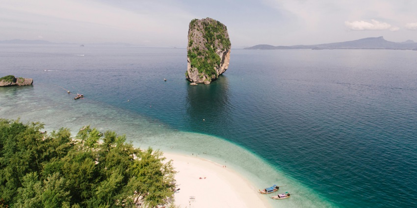 Witness the turquoise waters and lush green landscapes of Ao Prao Beach, Thailand.