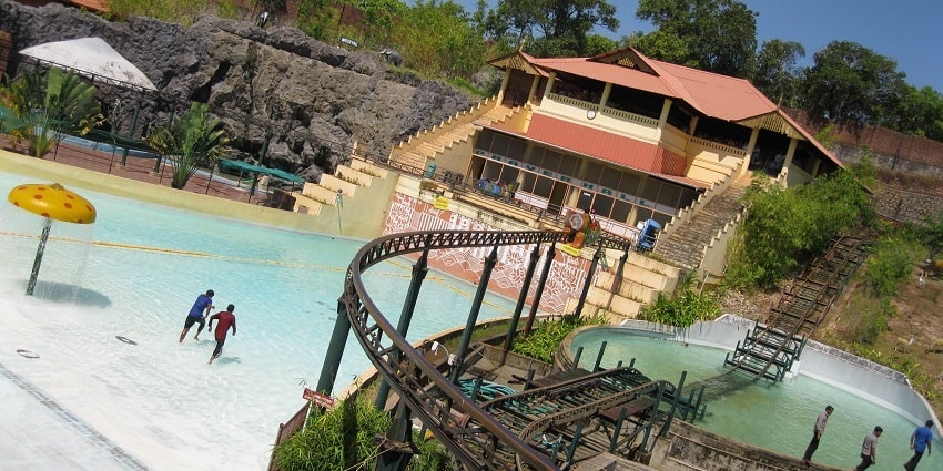 Famous water parks in Wayanad with people enjoying in the rain dance area