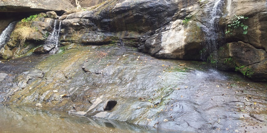 A picture of a waterfall in Ernakulam cascading down a rocky mountain