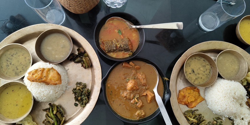 Assamese fish thali with a variety of flavorful dishes served on a traditional platter.