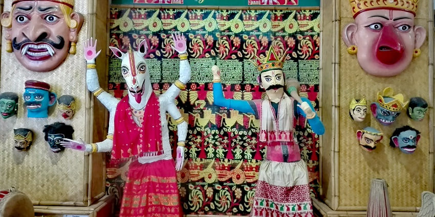 Assamese cultural display at Guwahati Airport traditional Mukha Xilpo masks and artistry.