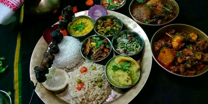 Assamese non-veg food served on a platter, showcasing a variety of flavorful dishes.