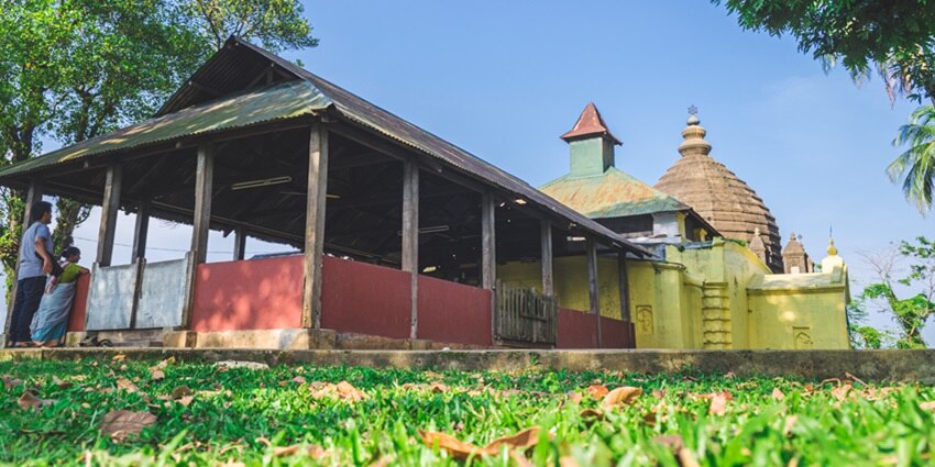 View of Aswaklanta Temple perched on a hill with scenic surroundings - Assam Temples.